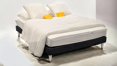 Lit moderne avec pieds de lit laqués gris-clair, ajoutant une touche déco raffinée à la chambre.